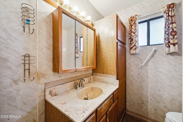 bathroom featuring vanity and toilet