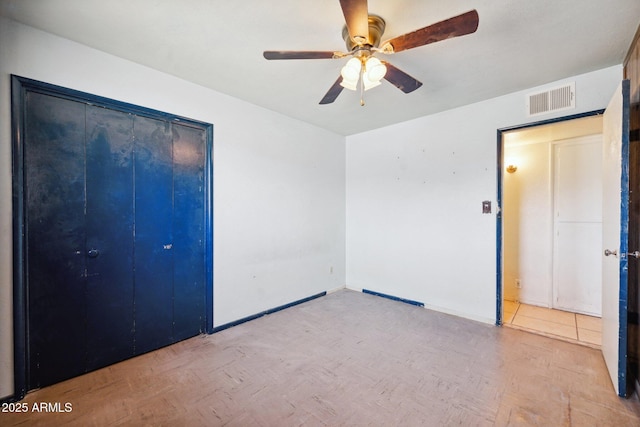 unfurnished bedroom with visible vents, ceiling fan, and baseboards