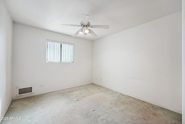 unfurnished room with a ceiling fan, light colored carpet, and visible vents