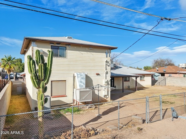 rear view of property with a patio area and a fenced backyard