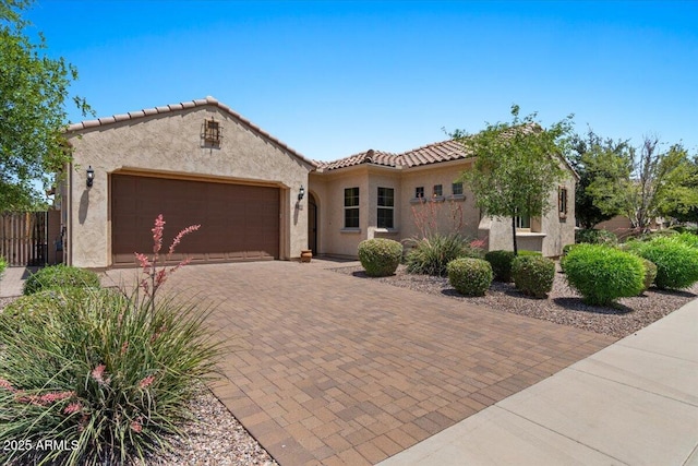 10914 E Tarragon Ave, Mesa, AZ 85212 - mediterranean / spanish-style house with an attached garage, stucco siding, a tile roof, and decorative driveway