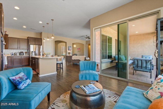 10914 E Tarragon Ave, Mesa, AZ 85212 - living room featuring arched walkways, dark wood finished floors, ceiling fan, and recessed lighting
