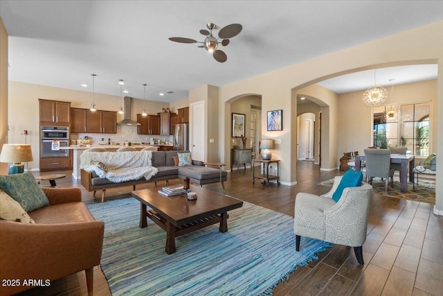 10914 E Tarragon Ave, Mesa, AZ 85212 - living area featuring dark wood-style floors, arched walkways, ceiling fan, a chandelier, and recessed lighting