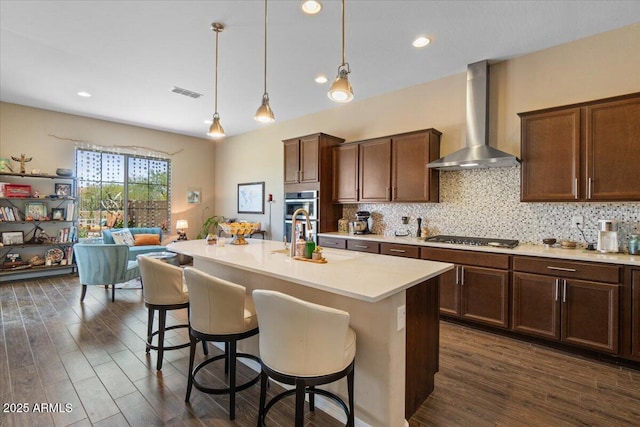 10914 E Tarragon Ave, Mesa, AZ 85212 - kitchen featuring wall chimney range hood, light countertops, dark wood finished floors, backsplash, and recessed lighting