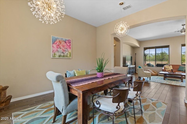 10914 E Tarragon Ave, Mesa, AZ 85212 - dining area with arched walkways, a chandelier, and wood finished floors
