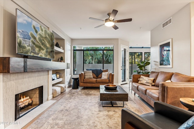 living room with light wood-type flooring and ceiling fan