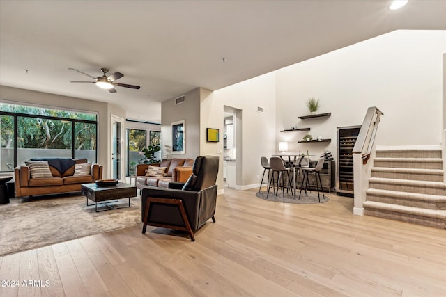 living room with ceiling fan and light wood-type flooring