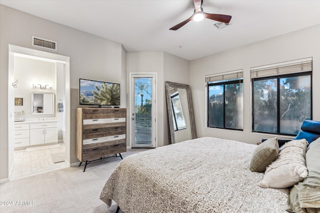 carpeted bedroom featuring connected bathroom and ceiling fan