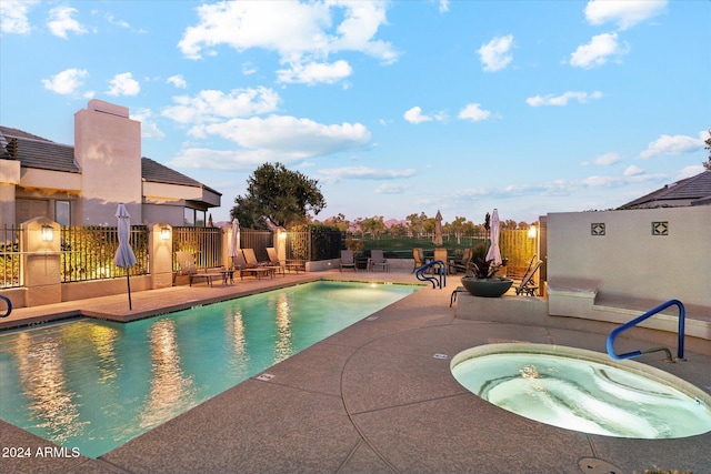 view of swimming pool featuring a community hot tub and a patio