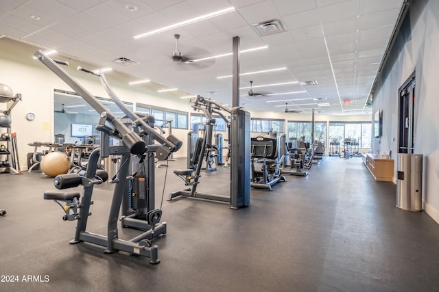 workout area featuring a paneled ceiling and ceiling fan