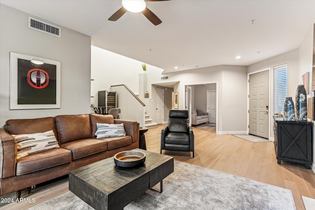 living room featuring light hardwood / wood-style flooring and ceiling fan