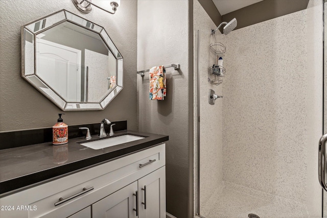 bathroom featuring vanity and tiled shower