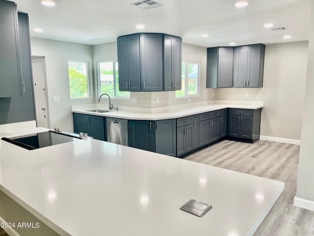 kitchen featuring visible vents, light wood-style flooring, dishwasher, and a sink