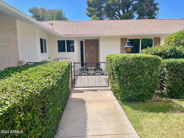 property entrance with a gate and fence