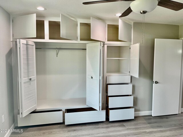 bathroom with wood-type flooring, an enclosed shower, vanity, and toilet