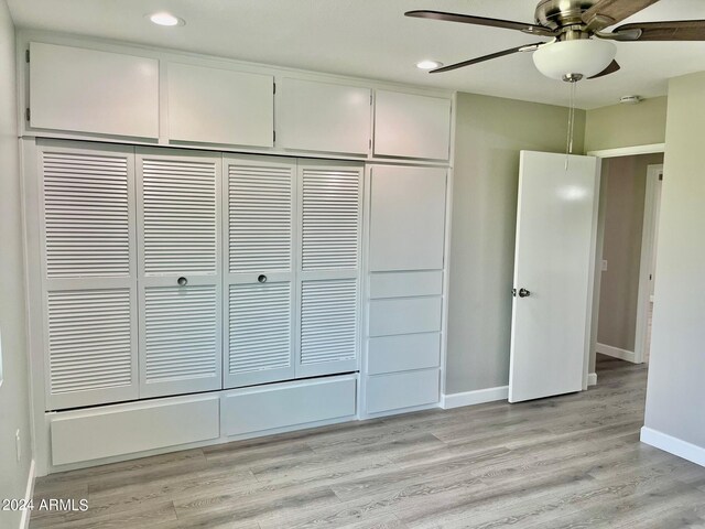 bathroom with shower / washtub combination and hardwood / wood-style floors