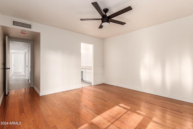 empty room featuring light hardwood / wood-style flooring and ceiling fan