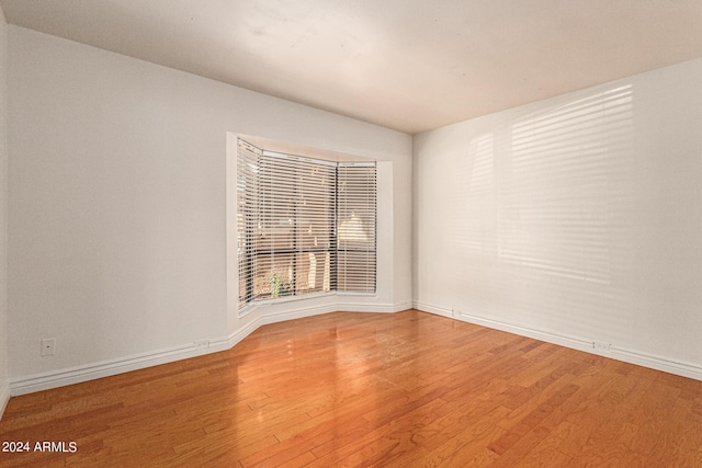 empty room with hardwood / wood-style flooring