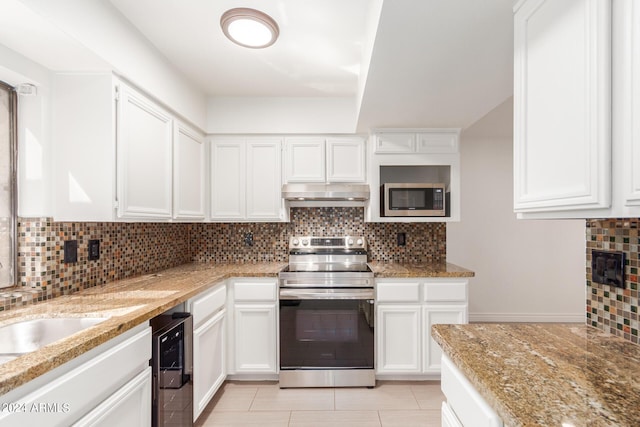 kitchen with appliances with stainless steel finishes, decorative backsplash, and white cabinets