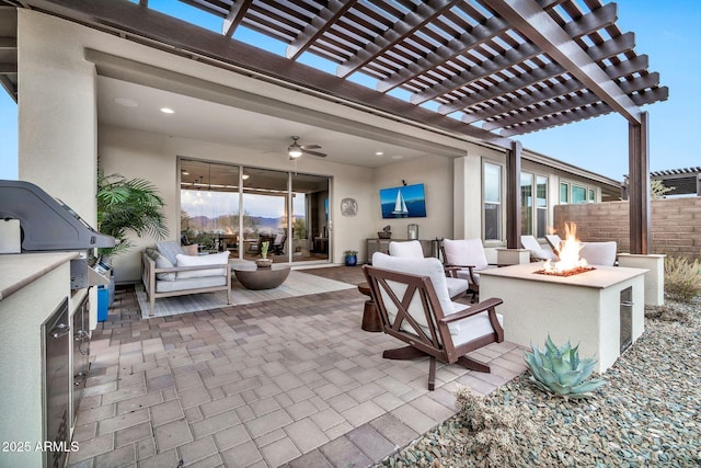 view of patio with ceiling fan, an outdoor living space with a fire pit, area for grilling, and a pergola