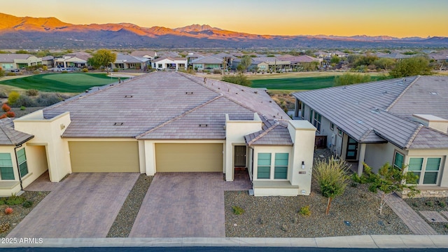 view of front of house featuring a garage and a mountain view