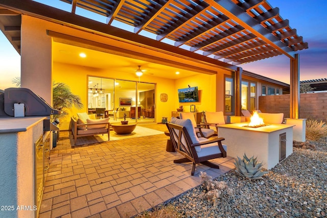 patio terrace at dusk featuring a pergola and an outdoor living space with a fire pit