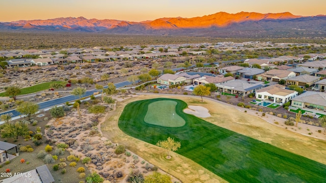 aerial view at dusk featuring a mountain view