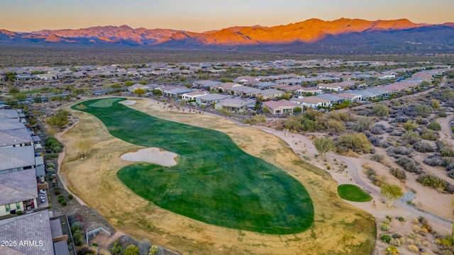 aerial view at dusk featuring a mountain view