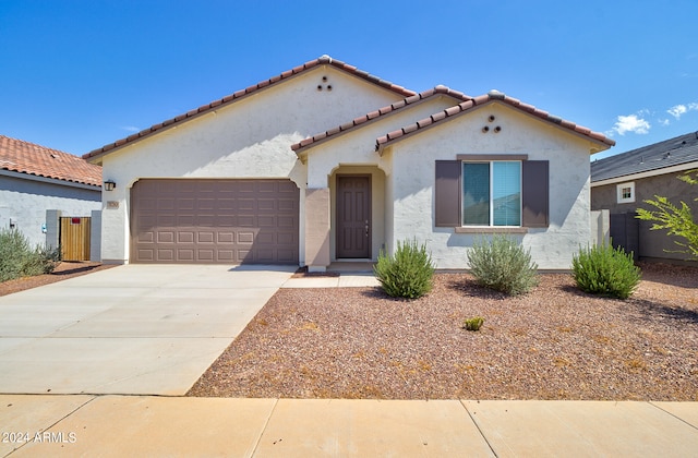 mediterranean / spanish-style home featuring a garage