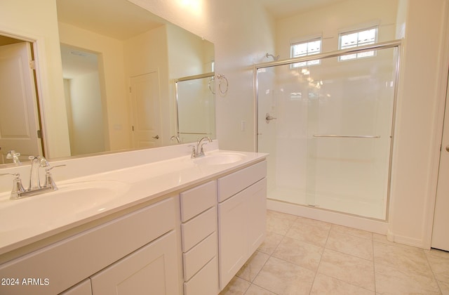 bathroom featuring vanity, an enclosed shower, and tile patterned flooring