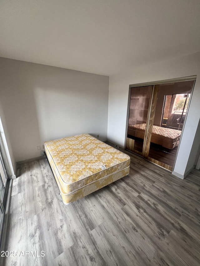 unfurnished bedroom with hardwood / wood-style floors