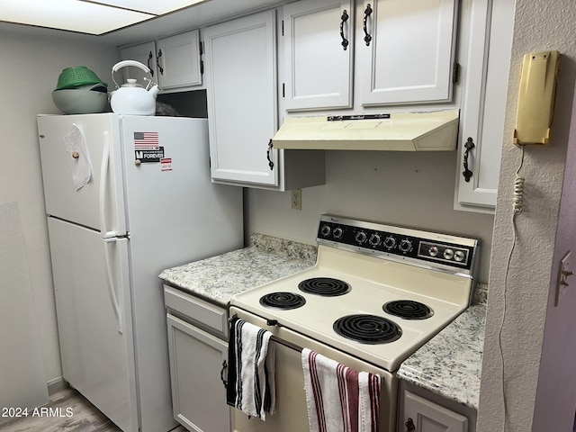 kitchen with white appliances and light hardwood / wood-style floors