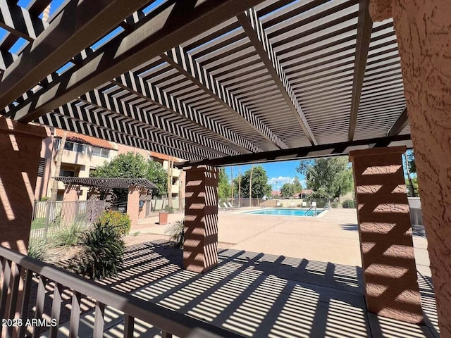 view of patio / terrace featuring a community pool and a pergola