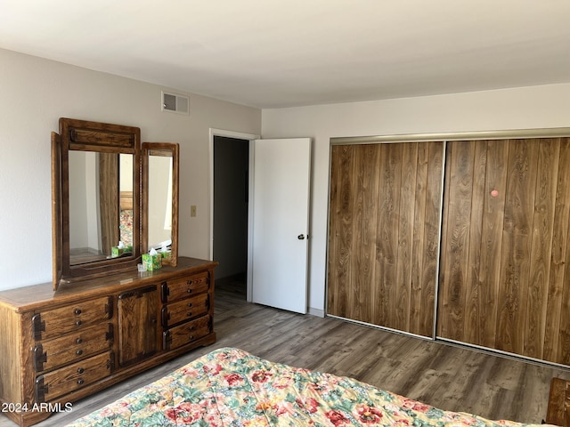 bedroom featuring dark wood-type flooring and a closet