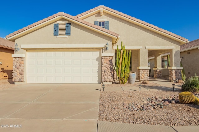 view of front of home with a garage, stone siding, driveway, and stucco siding