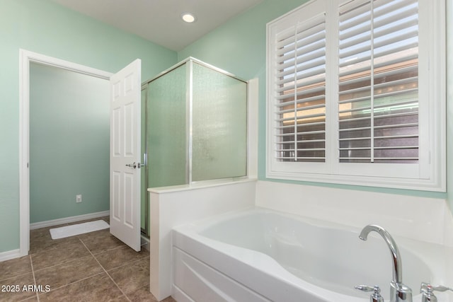 bathroom with recessed lighting, baseboards, a bath, tile patterned floors, and a stall shower