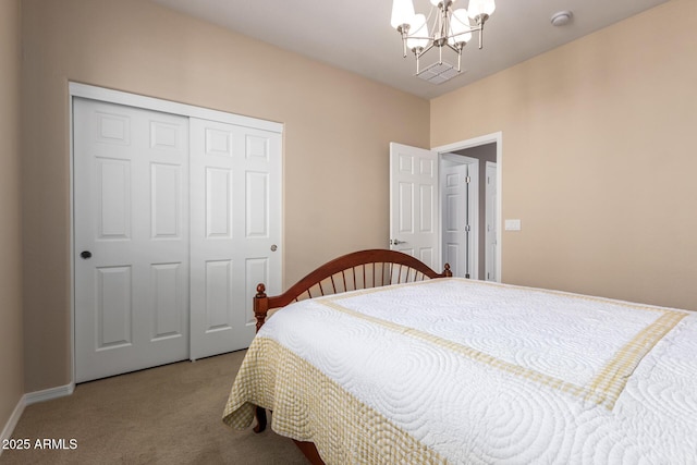 bedroom with carpet floors, a closet, and a notable chandelier