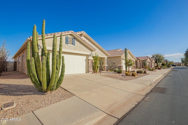 view of front of property featuring a garage, driveway, a residential view, and stucco siding