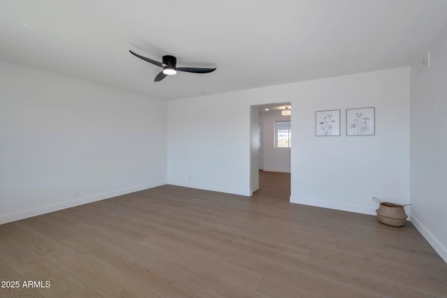 empty room featuring ceiling fan and light wood-type flooring