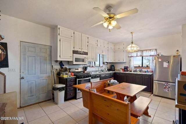 kitchen featuring a ceiling fan, light tile patterned flooring, light countertops, white cabinets, and appliances with stainless steel finishes