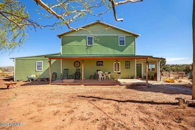 back of property with covered porch