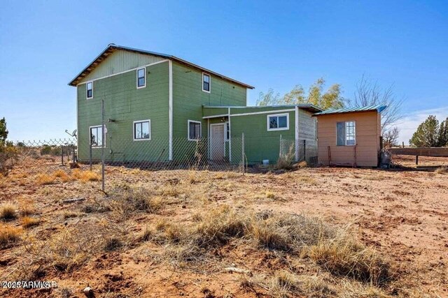 back of property featuring fence
