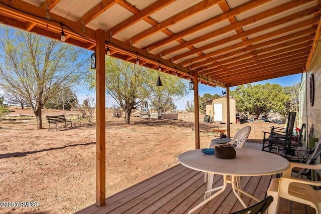 wooden terrace with an outbuilding and a storage shed