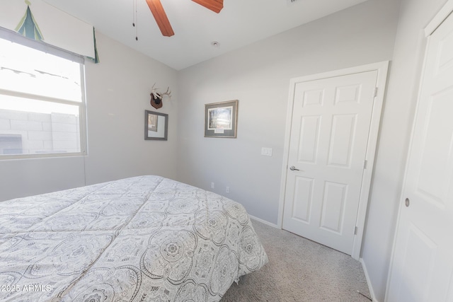 bedroom with ceiling fan, carpet, and baseboards