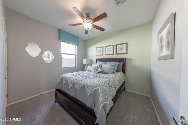 carpeted bedroom with a ceiling fan, visible vents, and baseboards