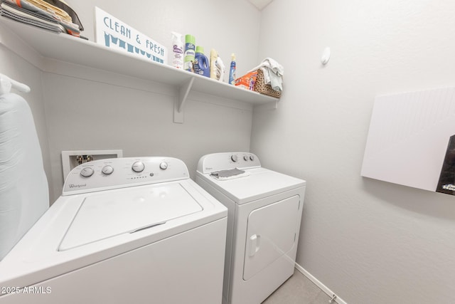 laundry area featuring laundry area, baseboards, and separate washer and dryer