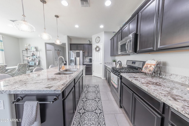 kitchen with recessed lighting, visible vents, appliances with stainless steel finishes, a sink, and light stone countertops