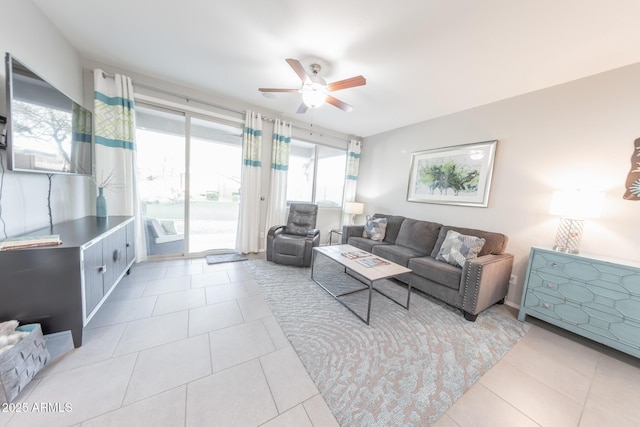 living area with a ceiling fan and tile patterned flooring