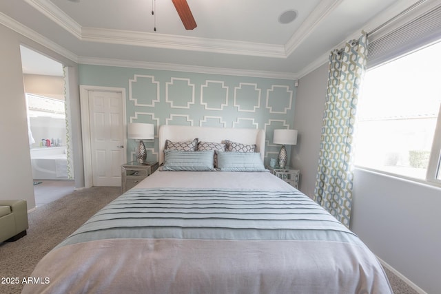 carpeted bedroom with a ceiling fan, a raised ceiling, and crown molding