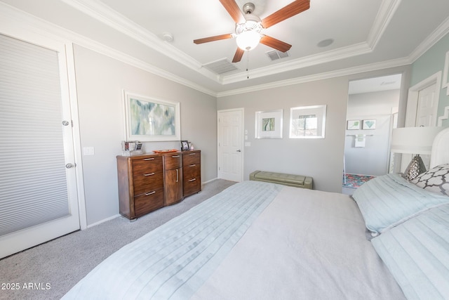 bedroom with ceiling fan, light colored carpet, visible vents, a raised ceiling, and crown molding